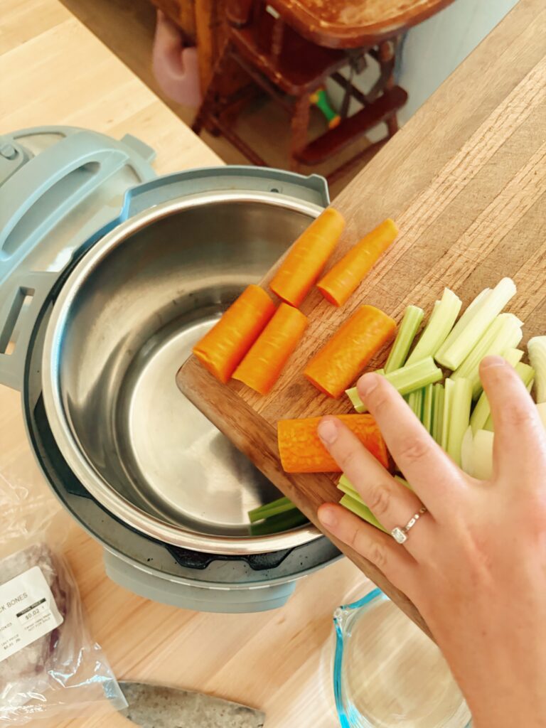 Adding the roughly chopped vegetables into the empty instant pot.