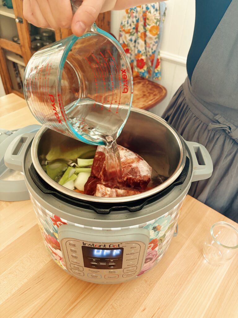 Adding the water into the instant pot.