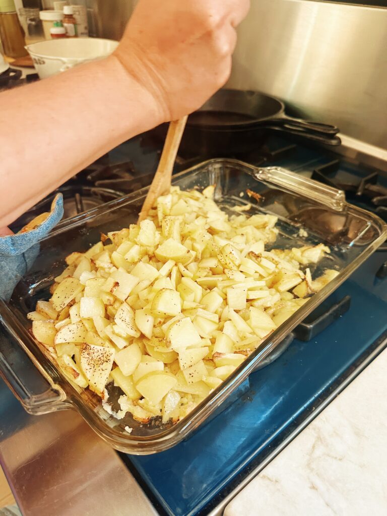 The person is mixing up this partially baked mixture with the other half of the salt and pepper added.