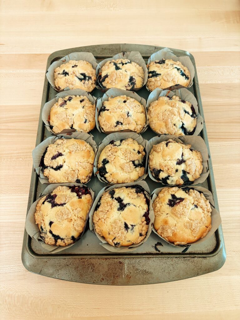 a photo of the muffins once they have been baked and have been pulled out of the oven, they are still in the tin and their papers. 